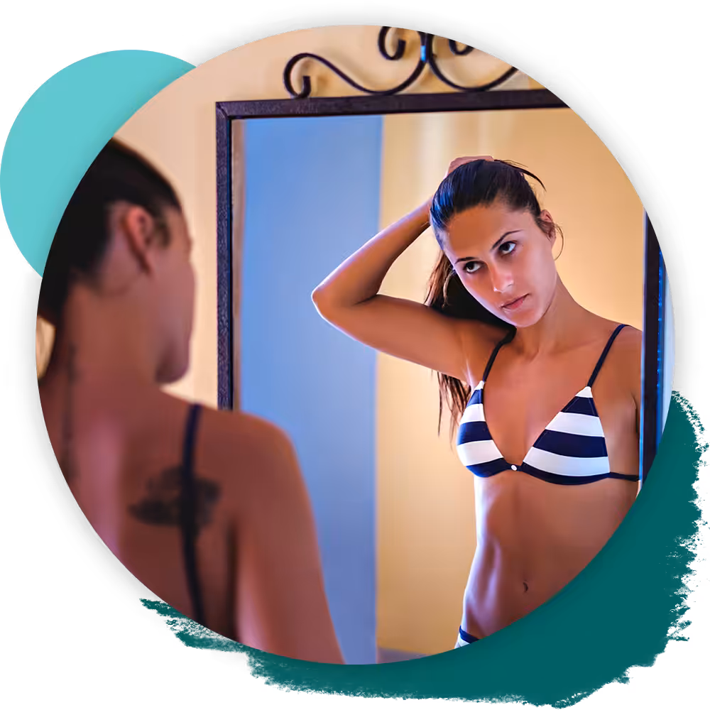 woman in front of mirror in bikini
