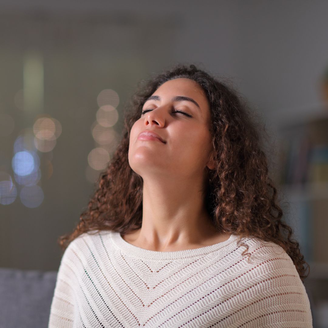 woman feeling rejuvenated after spray tan