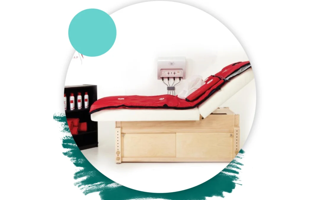 A spa bed with a red mat and blanket is shown with a control panel and products on a shelf.